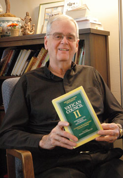 Father David Lawler, associate pastor of St. Christopher Parish in Indianapolis, holds a copy of the Second Vatican Council documents, which he often refers to while preparing his homilies. During 48 years of priestly ministry, he has served at five parishes as well as at the state’s largest hospital, where he enjoyed visiting the nursery to see the newborn babies. (Photo by Mary Ann Wyand)