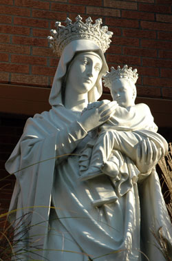 This statue of Our Lady of Perpetual Help greets people near the entrance to that parish church in New Albany. Father Eric Augenstein, the pastor, spent 12 hours hearing confessions on March 18 at the church dedicated to Mary. Six New Albany Deanery priests assisted Father Augenstein by hearing confessions for several hours throughout the day and evening. (File photo by Mary Ann Wyand)