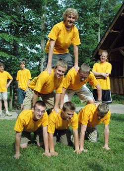 Several campers make a human pyramid during the 2008 Bishop Bruté Days, a vocations camp and retreat experience sponsored by Bishop Simon Bruté College Seminary in Indianapolis. The camplers are, from left, bottom row, Joe Linginfelter, Marshall Tobin and Vincent Jansen, and middle row, Byron Woods and Joseph Cole. On the top is Patrick Lockhart. Seminarian Tim Wyciskalla looks on from behind. Jansen and Cole are expected to be freshmen at Bishop Bruté in August. (File photo by Sean Gallagher)
