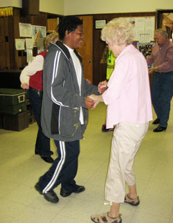 Kevin Thacker dances with an unidentified woman at a senior citizens center in Copperhill, Tenn., one of the ways that eighth-grade students from Holy Cross Central School in Indianapolis connected with people during a mission trip there this spring. (Submitted photo)