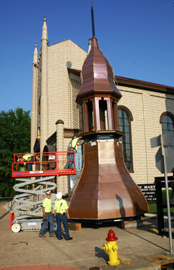 Workers from Abel Construction in Louisville connect two components of a new steeple for St. Mary Church in New Albany on July 14. (Submitted photo)
