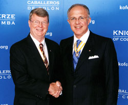 Charles Maurer, left, shakes hands with Carl Anderson, the supreme Knight of the Knights of Columbus, during a June meeting at the organization’s headquarters in New Haven, Conn. Maurer, a member of St. Andrew Parish in Richmond, was recently appointed the Knights of Columbus’ supreme treasurer, one of its highest offices. (Submitted photo)