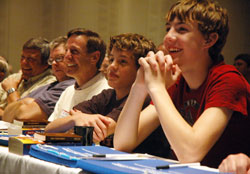 Jim Dickey, third from left, and his two sons, Connor and Jordan, laugh during a talk given by Father Larry Richards during the fifth annual Indiana Catholic Men’s Conference on Oct. 16 at the Indiana Convention Center in Indianapolis. Dickey, an organizer of the conference, and his family are members of St. Louis Parish in Batesville. (Photo by Sean Gallagher)