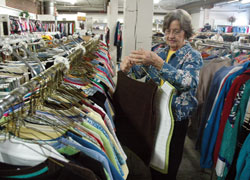 Betty Farrell sorts donated clothing on Oct. 7 at the St. Vincent de Paul Distribution Center in Indianapolis. A member of St. Lawrence Parish in Indianapolis, Farrell is the volunteer manager of the facility. (Photo by Sean Gallagher)