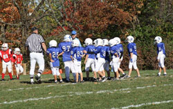 Coach Darrell Dolan huddles with the players from the third-grade football team at St. Simon the Apostle Parish in Indianapolis during the 2010 season. (Submitted photo)