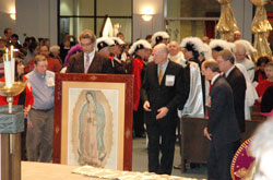 Members of the Committee of Guadalupe process into Our Lady of the Greenwood Church with a framed image of Our Lady of Guadalupe on Dec. 10 before the start of the 15th annual solemn Mass honoring the Patroness of the Americas. The frame that holds the image was hand-carved in Mexico. (Photo by Mike Krokos)