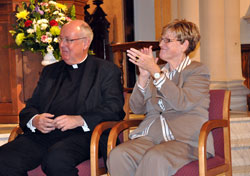 Msgr. Joseph F. Schaedel, left, and Annette “Mickey” Lentz, the archdiocesan chancellor, applaud as Bishop-designate Christopher J. Coyne is introduced during a Jan. 14 press conference at St. John the Evangelist Church in Indianapolis. Msgr. Schaedel will begin a three-month sabbatical in Rome in February. He has served as the vicar general of the archdiocese for 17 years, and also ministered as the pastor of Our Lady of the Most Holy Rosary Parish in Indianapolis. (Photo by Mary Ann Wyand)