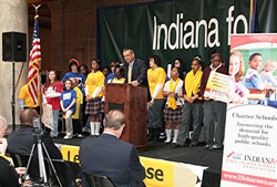 Indiana Superintendent of Public Instruction Tony Bennett discusses the merits of education reform legislation during a March 30 school choice rally at the Indiana Statehouse in Indianapolis. Bennett is surrounded by charter school students from across the state. (Photos by Charles J. Schisla)