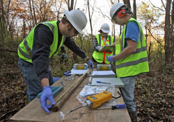 Paul Melillo, left, and Mark Breting, right, inspect soil samples in 2009 from land in Wildwood, Mo., that had been contaminated with dioxin, PCBs and organic chemicals. The employees of Mundell and Associates, an Indianapolis-based environmental services consulting firm, are assisted by Ed Paschal, center, a private environmental consultant for the City of Wildwood. (Submitted photo)