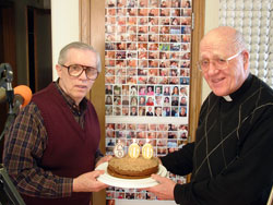 Standing in the studio of WHOJ 93.1 FM on March 12, Ron Eldred, left, and Msgr. Lawrence Moran hold a cake honoring Msgr. Moran’s 600th show broadcast on the Terre Haute-based Catholic radio station. Its studio is in the rectory of St. Patrick Parish in Terre Haute. Eldred, who teaches religion and history at John Paul II High School in Terre Haute, has helped produce hundreds of Msgr. Moran’s shows. (Submitted photo)