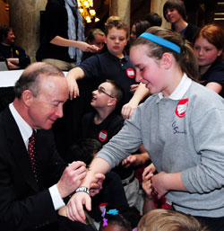 Gov. Mitch Daniels signs Celia Ward’s arm following the school choice bill signing ceremony on May 5. Celia is a fourth-grade student at Central Catholic School in Indianapolis, one of four schools which make up the Mother Theodore Catholic Academies in Indianapolis. (Photo courtesy of Governor’s Office)