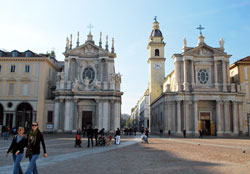 People walk across a plaza in Turin, Italy, near the twin churches of Santa Christina, left, and San Carlo. (Submitted photo/Fr. Louis Manna)