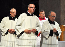 Processing out of SS. Peter and Paul Cathedral in Indianapolis at the conclusion of an Aug. 14 Evening Prayer liturgy are, from left, Msgr. Paul Richart, Msgr. William Stumpf, Msgr. Anthony Volz and Msgr. Joseph Riedman. Earlier this year, Pope Benedict XVI gave these priests and the late Msgr. Joseph Kern the title of monsignor. (Photo by Sean Gallagher)