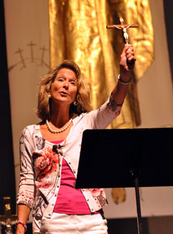 Catholic author Katrina Zeno of Phoenix holds a crucifix on Sept. 17 while explaining Church teachings on the resurrection of the body. She was one of three keynote speakers during “God Alone,” the 2011 Indiana Catholic Women’s Conference, at Cathedral High School in Indianapolis. (Photo by Mary Ann Garber)