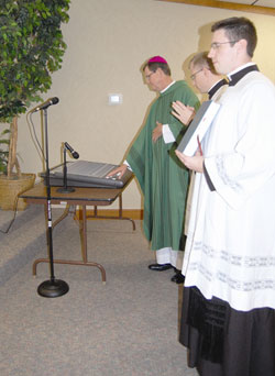 Bishop Timothy L. Doherty ceremonially “throws the switch” for the new Catholic radio station in Noblesville on Oct. 12. (Photo by Caroline B. Mooney/The Catholic Moment)