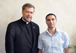Franciscan Father Peter Vasko, left, president of the Franciscan Foundation for the Holy Land, poses on Sept. 21 at the Archbishop O’Meara Catholic Center in Indianapolis with Zaki Sahlia, a Palestinian Catholic from Israel. Sahlia was visiting the United States to visit with and thank donors to the foundation who made possible college scholarships for himself and other young adult Palestinian Catholics. (Photo by Sean Gallagher)