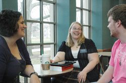 As a chaplain’s apprentice to Father Jeffrey Godecker at Butler University in Indianapolis, Kaitlyn Willy, center, always looks for different ways to connect with the college’s Catholic students. Here, she shares a laugh with Meggie Gallina, a member of St. Elizabeth Ann Seton Parish in Carmel, Ind., in the Lafayette Diocese, and Steven Meuleman, a member of St. Lawrence Parish in Indianapolis. (Photo by John Shaughnessy)