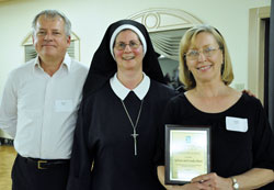 Our Lady of the Greenwood parishioners Sylvan Ebert, left, and Linda Ebert of Greenwood were among four recipients of 2012 Sanctity of Life Awards presented by Servants of the Gospel of Life Sister Diane Carollo, director of the archdiocesan Office for Pro-Life Ministry, during the office’s third annual Sanctity of Life awards dinner and fundraiser on March 8 in Indianapolis. The Eberts are dedicated Birthline volunteers. (Photo by Mary Ann Garber)