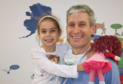 Six-year-old Litzy Maria Luna Mendoza of Cuba gives a special hug to Dr. Martin Kaefer, a physician at Riley Hospital for Children in Indianapolis and member of Immaculate Heart of Mary Parish in Indianapolis, who performed a life-changing surgery for the girl on Feb. 20. (Photo by Charles Schisla)