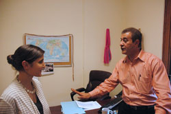As World Refugee Day nears on June 20, Gabrielle Neal, director of the archdiocese’s Refugee Resettlement Program, talks with Sajjad Mohammed Jawad, the 2011 Refugee of the Year who now works for Catholic Charities Indianapolis helping refugees adjust to life in central Indiana. (Photo by John Shaughnessy)