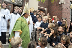 Patriarch Fouad Twal greets Lumen Christi Catholic School students on Sept. 28 on the steps of Our Lady of the Most Holy Rosary Church in Indianapolis after celebrating Mass with them. Patriarch Twal, the Latin Patriarch of Jerusalem, visited Indianapolis for a meeting of the Equestrian Order of the Holy Sepulchre of Jerusalem, an international Catholic organization that supports the Church in Cyprus, Israel, Jordan and the Palestinian territories. (Photo by Sean Gallagher)