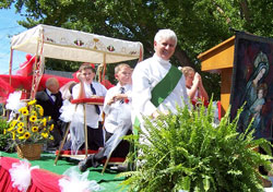Permanent deacon Rick Cooper rides on St. Mary Parish’s float on Sept. 15. (Submitted photo)