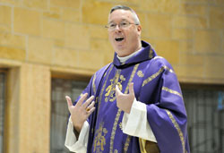 Bishop Christopher J. Coyne, apostolic administrator, shares a funny story at the start of his homily during the African Catholic Mass on Dec. 4, 2011, at St. Rita Church in Indianapolis. (File photo by Mary Ann Garber)