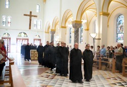 Benedictine Monks of Saint Meinrad Archabbey in St. Meinrad process into their Archabbey Church of Our Lady of Einsiedeln on Aug. 6, 2012, just before praying Evening Prayer. (Photo courtesy of Saint Meinrad Archabbey)