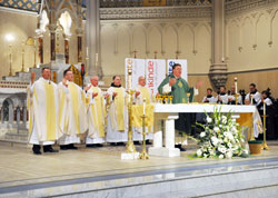 Archbishop Joseph W. Tobin, center, concelebrates Mass on Jan. 19 with, from left, Fathers Rick Nagel, Michael O’Mara, George Plaster, Franciscan Father Lawrence Janezic, Father John Hall and Father Thomas Murphy (seated to the right of the altar). Father Hall was baptized and raised in St. John the Evangelist Parish in Indianapolis, and Father Murphy is a former pastor of the parish. (Photo by Natalie Hoefer)