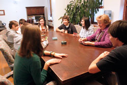 Franciscan Sister Therese Gillman enjoys a fun moment of playing cards with the students who are part of her “Marathon Monday” group, part of a program that connects students and staff members to come together to relax and talk about school, community and world issues. (Submitted photo)