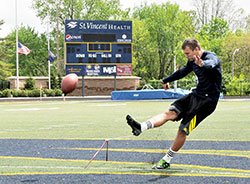 Michael Josifovski practices kicking field goals on May 6 at St. Vincent Health Field at Marian University in Indianapolis. Josifovski, a star kicker for the past two seasons for Marian’s national championship football team, will participate in the Indianapolis Colts’ rookie minicamp from May 10-12. (Photo by Sean Gallagher)