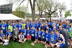 Members of the Race for Vocations team pose on May 4 outside the team’s tent in Military Park in Indianapolis after they participated in either the OneAmerica 500 Festival Mini-Marathon or the Finish Line 500 Festival 5K. The approximately 300 team members wore shirts that promoted the belief that every person has a vocation from God. (Submitted photo)