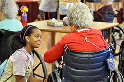 Mary Peach enjoys a conversation with a resident at the Golden LivingCenter nursing home in Greenfield on June 19. The visit to the nursing home was one of four service opportunities for participants at the “Girls Getaway” three-day service camp offered through the Challenge program at St. Michael Parish in Greenfield. (Photo by Natalie Hoefer)