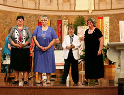 Four women professed perpetual vows as Sisters of Providence of Saint Mary-of-the-Woods in the Church of the Immaculate Conception at Saint Mary-of-the-Woods on June 30. From left, Providence Sisters Deborah Campbell, Laura Parker, Patty Wallace and Beth Wright stand before the gathered assembly immediately after professing their vows. (Submitted photo)