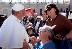 Pope Francis takes time to talk with Mary Kubala, seated, and Vicki Stark after the two members of St. Anne Parish in New Castle attended an audience with the pope last fall in St. Peter’s Square at the Vatican. (Photo by Fotografia Felici Roma) 