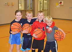 Claire Clemmer-Becht, left, Xavier Jansen, Drew Cassis and Knox Betourne were teammates on a team in the kindergarten division of a six-week youth basketball league that took place earlier this year at St. Mary-of-the-Knobs Parish in Floyd County. (Submitted photo)