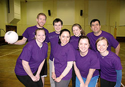 Sports set the stage for opportunities to embrace and deepen the faith of young adult Catholics in the archdiocese’s recently started Young Adult Catholic Intramural Program. Members of the Unstop-Purples volleyball team pose for a team picture after a game on March 4. Players are, front row, Jennifer Peterson, left, Veronica Fuentes, Katie Sahm and Sarah Pluckebaum. Back row, Eric Burns, left, Dan Klee, Katie Klee and Jose Del Real. (Photo by John Shaughnessy)