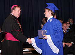 Archbishop Joseph W. Tobin congratulates Jackson Lucas during the 2013 graduation ceremony of Bishop Chatard High School in Indianapolis. (Submitted photo Bishop Chatard High School Photography)