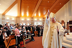 Bishop Christopher J. Coyne, then-apostolic administrator, blesses members of the congregation at the conclusion of the March 25, 2012, Mass of Dedication at the new St. Mary-of-the-Knobs Church in Floyd County. Bishop Coyne will assume pastoral responsibility for the New Albany, Seymour and Tell City deaneries in the southern part of the archdiocese on Oct. 1. (Criterion file photo)