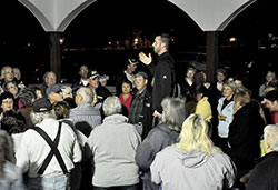 Father Dustin Boehm, center, pastor of St. Gabriel Parish in Connersville and St. Bridget of Ireland Parish in Liberty, gives instructions in the pavilion at Roberts Park in Connersville to more than 150 people on Oct. 12—prior to the first of nine parish-led Sunday evening rosary walks, praying for those suffering from addictions and their families. Connersville has had a recent upsurge in overdoses and deaths due to heroin use. (Photo by Natalie Hoefer)