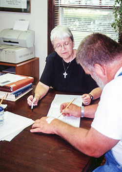 Providence Sister Margaret Quinlan teaches an adult student at Education/Family Services in Terre Haute in 2000. After 20 years of ministry, the program of Guerin Outreach Ministries, Inc., which is sponsored by the Sisters of Providence of Saint Mary-of-the-Woods, will close its doors on Jan. 31. (Submitted photo)
