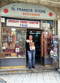 Alfred Ra’ad stands inside the door of St. Francis Store, a souvenir shop in Old City Jerusalem, on March 13. A decline in the number of pilgrims visiting the Holy Land—plus a growing sense of persecution—have led to hard times for Ra’ad and his family. (Submitted photo)