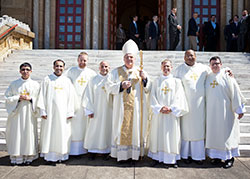 Archbishop Joseph W. Tobin, center, poses on April 11 outside of the Archabbey Church of Our Lady of Einsiedeln in St. Meinrad with transitional deacons Nicolás Ajpacajá Tzoc, Meril Sayaham, Kyle Rodden, Matthew Tucci, Anthony Hollowell, Douglas Hunter and James Brockmeier, all of whom will serve the Church in central and southern Indiana. Archbishop Tobin ordained the men during a Mass celebrated that day at the church. (Photos courtesy of Saint Meinrad Archabbey)