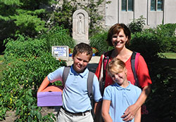 Tracy Ross and her children, Jack and Hanna, pose for a photo in the community garden at Immaculate Heart of Mary Parish in Indianapolis on Aug. 7. The garden provides fresh produce for people in need. (Photo by John Shaughnessy)