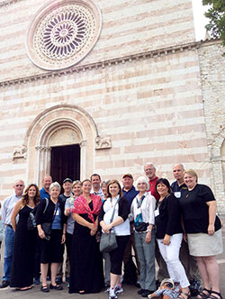 Pilgrims from Marian University in Indianapolis stand in front of the Basilica di Santa Chiara in Assisi, Italy, which houses St. Clare’s remains and the original San Damiano Crucifix. (Submitted photo)