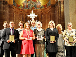 Five individuals were honored by the archdiocese on Sept. 2 during the Administrators’ Mass at SS. Peter and Paul Cathedral in Indianapolis. The honorees, all in the front row, are Andrew Costello, left, John Paul II Young Adult Servant Leader Award recipient; Amy Wilson, St. Theodora Excellence in Education Award winner; Julie Haney, Excellence in Catechesis Award recipient; and Carol Wagner and Patty Cain, who both received the Youth Ministry Servant Leader of the Year Award. In the back row are Matt Faley, left, director of young adult and college campus ministry for the archdiocese; Gina Fleming, superintendent of Catholic schools for the archdiocese; Ken Ogorek, director of catechesis for the archdiocese; and Kay Scoville, director of youth ministry for the archdiocese. (Photo by John Shaughnessy)