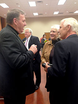 Archbishop Joseph W. Tobin talks with Yvonne and Ken Abell, members of St. Mary Parish in Lanesville, during the Oct. 8 Miter Society gathering at St. Mary-of-the-Knobs Parish in Floyd County. Shown in the background is Larry Ricke, a member of St. Mary Parish in New Albany. (Photo by Leslie Lynch)