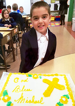 For most of his nine years, Michael Deiter has faced the continuing prognosis that he “could die at any time.” Here, the third-grade student at Our Lady of Lourdes School in Indianapolis is all smiles shortly after he celebrated a major moment in his spiritual life—receiving his first Communion. (Submitted photo)
