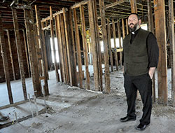 Father Aaron Jenkins, pastor of St. Michael Parish in Greenfield, stands in a dilapidated house in Greenfield that Friends of Recovery, an ecumenical ministry in Hancock County, hopes to renovate so it can serve as a home for women in recovery from addictions. St. Michael Parish supports Friends of Recovery. (Photo by Sean Gallagher)