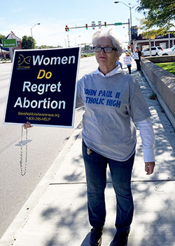 Judy Sweeney, a member of Sacred Heart of Jesus Parish in Terre Haute, holds a sign stating that women regret abortion during last year’s Life Chain in Terre Haute on Respect Life Sunday on Oct. 4. The Archdiocese of Indianapolis offers many post-abortion healing ministries. (File photo submitted by Tom McBroom)